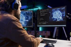 Programmer listening music while doing maintenance on artificial intelligence neural networks computerized model. Tech support expert using headphones and doing checkup on AI systems photo