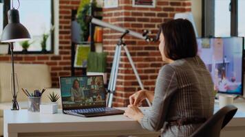 Remote professional holding q and a session with webinar participants via videoconference meeting in cozy apartment. Online videocall host engaging in online discussions with trainees, camera B photo