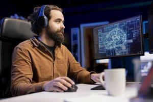 Programmer listening music while using artificial intelligence computing simulating human brain. Freelancing IT professional wearing headphones to hear podcasts, working with AI deep neural networks photo