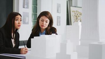 Developers team creating floor plan blueprint in agency office, measuring 3d printed building scale and elements. Architects working with maquette to capture accurate dimensions of physical spaces. photo