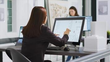 Designer produces plans for household renovation project using CAD program on pc to create new designs for individuals. Technician conducts calculations on interior drawings at workplace. photo