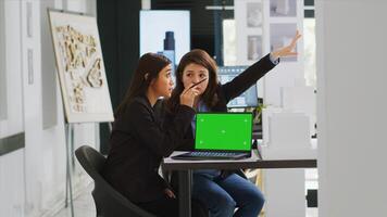 Team of architects working with greenscreen layout on pc, planning new building project for urban development. Technicians developing new drafts for construction blueprints and sketches. photo