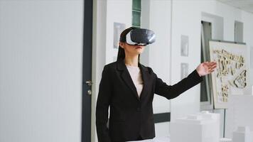 Architect working on new project with vr headset in office, developing industrial plan to remodel building property at unicorn business agency. Woman using virtual reality metaverse tech. photo