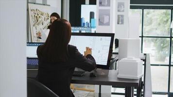 Developer sketching remodeling plan lines on touch screen pc, working with industrial manufacturing app in agency office. Project engineer drawing new draft of the future property floor plan. photo
