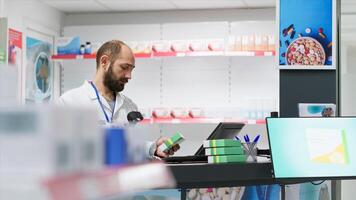 Healthcare workers arranging all pharmaceuticals on shelves, organizing medicaments or dietary supplements at pharmacy counter. Two pharmacists checking and scanning all products and remedies. photo