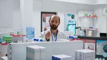 Pharmacist doing inventory using hologram projection, counting boxes of medicaments and supplements. Drugstore employee working on procuring medical supplies, artificial intelligence. Camera 1. photo