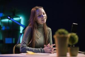 Smiling girl filming herself discussing topics of interest for generation Z audience watching her online social media content. Happy influencer recording targeting gen Z viewers photo