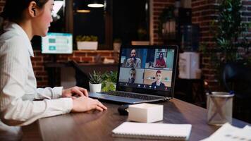 Office clerk making report to board of directors during company meeting on videocall. Worker participating in corporate remote videoconference telework call, presenting project photo