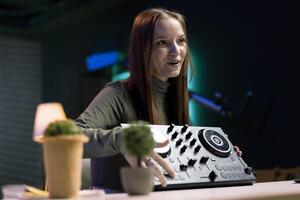 Content creator doing giveaway for online channel subscribers, offering DJ controller device to most loyal fan. Media star happy to gift viewers professional sound mixer, doing contest photo