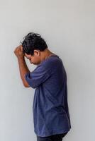 a frustrated or stressed adult man isolated on white background with copy space suitable for mental health content photo
