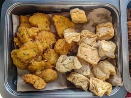 A traditional Indonesian breakfast or snack a mix of fried tempeh and bakwan. photo