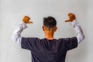 a young man who raised his hands and faced his back because he was caught by the police. isolated on white background photo