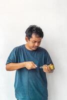 Adult man connecting a mic jack, isolated on white background. The image captures a man in casual attire setting up audio equipment. Perfect for themes related to technology, sound, and music. photo