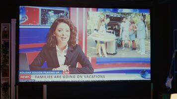 News reporter covering different subjects on VOD streaming service channel. Zoom out shot of smart TV in empty dimly lit apartment living room showing journalist talk about reportages photo