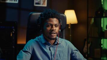 African american gamer engaging in online competitive multiplayer match using cutting edge gaming setup. Close up shot of man at home captivating spectators during live broadcast, playing videogames photo