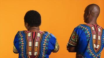 Back view of african american people stopping each other from talking, being frustrated and angry. Man and woman getting tired of listening to complaints from partner, interrupting argument. photo