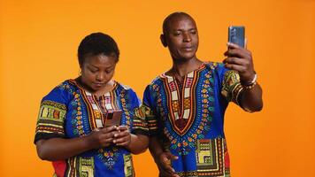 Married man and woman waving hi on web videocall network, using internet connection and link to speak with family members. Young couple holding mobile phone to chat to people. photo