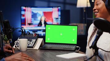 Isolated screen laptop next to analog mixer used by show host recording podcast in studio. Chroma key notebook near man professional audio device in live broadcast ensuring flawless sound quality photo