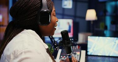 Zoom in on influencer in studio using high tech microphone for online show on livestreaming channel. Woman doing podcasting session with professional streaming sound gear, close up shot photo