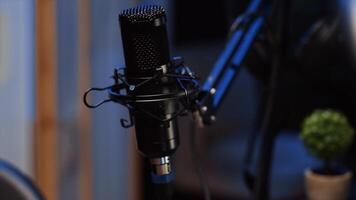 Zoom in shot of high tech microphone used to produce quality online show for livestreaming channel. Professional streaming sound capturing and recording podcasting gear in empty apartment photo