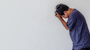 a frustrated or stressed adult man isolated on white background with copy space suitable for mental health content photo
