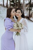 Two women are hugging each other and one of them is holding a bouquet of flowers. The scene is set in a snowy environment, which adds a sense of warmth and intimacy to the moment photo
