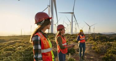 Female engineers using tablets to monitor and manage wind turbine operations on site.Generated image photo