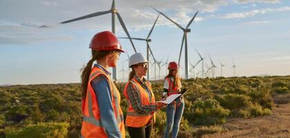 Female engineers using tablets to monitor and manage wind turbine operations on site.Generated image photo