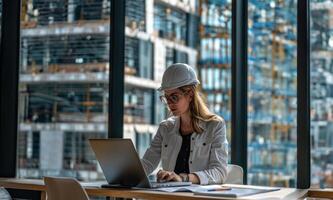 Young professional female engineer creating drawings on a computer in an office at a construction site.Generated image photo