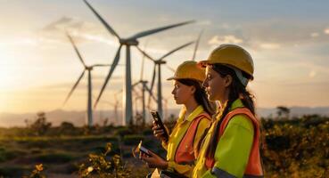 Female engineers using tablets to monitor and manage wind turbine operations on site.Generated image photo