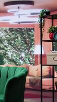 Vertical Modern empty home interior featuring green chairs and cozy wooden table, natural light. Panoramic view of the forest and contemporary design create a comfortable atmosphere in the cottage. video