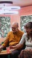 Vertical Elderly people drinking effervescent vitamins dissolved in water glasses, using for recovery and hydration. Senior couple taking supplements for wellness and longevity, health care. Camera B. video