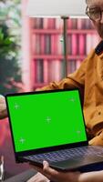 Vertical Senior woman with disability asking nurse for advice and medicine, doing consultation at home next to chroma key copy space screen. Old patients discussing about treatment for recovery. Camera A. video