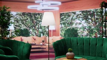 Cozy empty room with elegant green furniture and natural light with panoramic windows that offer a scenic view of the forest. Modern home decor, comfortable and stylish with an open floor plan. video