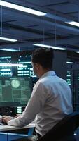 Vertical Team of programmers in server hub try to protect hardware from hacker attack stealing sensitive information. Data center cybersecurity division coworkers fight virus during security breach, camera B video
