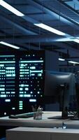 Vertical Person with paraplegia in inclusive server hub overseeing data center, making improvements. Woman in wheelchair doing tasks in data center, tracking network traffic, camera B video