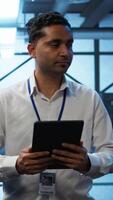 Vertical Security analyst in data center monitoring security threats, implementing cybersecurity measures. Expert ensuring compliance with regulations to protect data center assets, camera B video