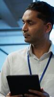 Vertical Security analyst in data center monitoring security threats, implementing cybersecurity measures. Expert ensuring compliance with regulations to protect data center assets, camera A video