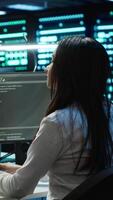 Vertical Management executive in data center ensuring system can handle networking tasks. Coworkers doing brainstorming in server room, tracking network traffic with PC, making improvements, camera A video