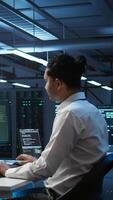 Vertical Computer scientists in server room protect hardware from hacker attack stealing sensitive information. Data center cybersecurity division teamworking colleagues fighting security breach, camera B video