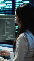 Vertical Data center call center agent responsible for providing logistics support to businesses. Worker in server farm establishment oversees infrastructure systems and communicates with engineers, camera A video