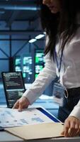 Vertical Programmer in data center arriving in office, being tasked with ensuring system can handle networking tasks. IT specialist in server farm starting job shift, tracking network traffic with PC, camera B video