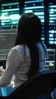 Vertical Engineer using augmented reality tech in data center, installing software, troubleshooting issues. IT expert in server hub looks at AR hologram, establishing performance benchmarks, camera A video