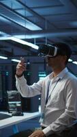 Vertical Engineer wearing VR headset in data center installing software on computer, troubleshooting issues. IT expert in server hub using virtual reality tech, establishing performance benchmarks, camera B video