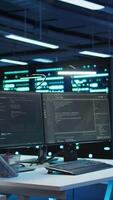 Vertical Computers in data center used for managing equipment rackmounts energy consumption. Panning shot of PC monitors in high tech establishment used for automation and monitoring processes in server hub video