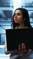 Vertical System administrator in high tech data center managing and maintaining databases, ensuring data integrity, security and availability. Manager overseeing server room, upgrading supercomputers systems video