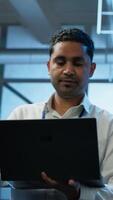 Vertical System administrator in data center managing servers, operating systems and software applications. Expert in server hub ensuring networks are secure, up to date, and functioning properly, camera A video