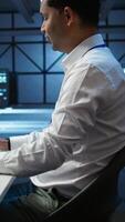 Vertical Engineer overseeing data center, making routine improvements and updates to ensure system can handle all networking tasks. Server room employee tracking network traffic and activity, camera B video