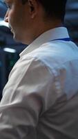 Vertical Computer scientist overseeing data center, making improvements and updates to ensure system can handle networking tasks. Close up of woman in server room tracking network traffic, camera B video