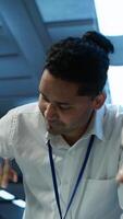 Vertical Teamworking colleagues in high tech data center managing and maintaining databases, ensuring data integrity, security and availability. Team of specialists updating server room systems, camera A video